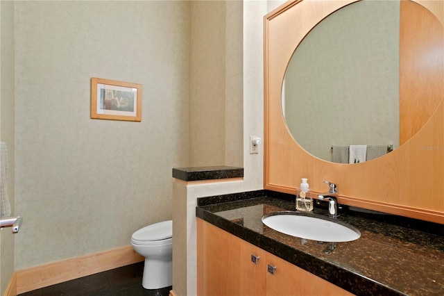 bathroom featuring tile patterned floors, baseboards, toilet, and vanity