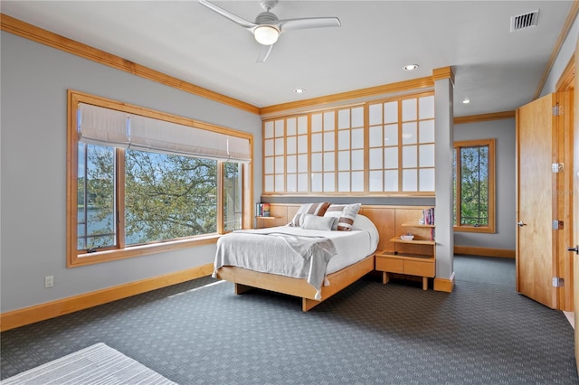 bedroom featuring visible vents, multiple windows, carpet flooring, and crown molding