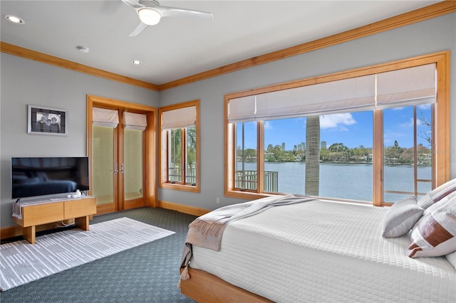 bedroom featuring a water view, ornamental molding, access to outside, carpet floors, and baseboards