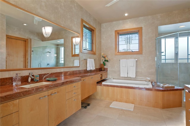 full bathroom featuring vanity, a garden tub, a stall shower, and tile patterned floors