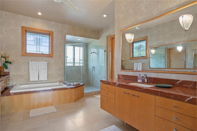 bathroom featuring a garden tub, vanity, a healthy amount of sunlight, and a shower stall