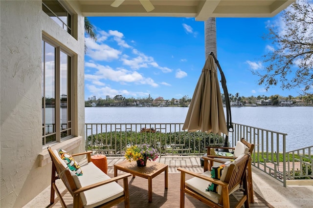 exterior space with ceiling fan and a water view