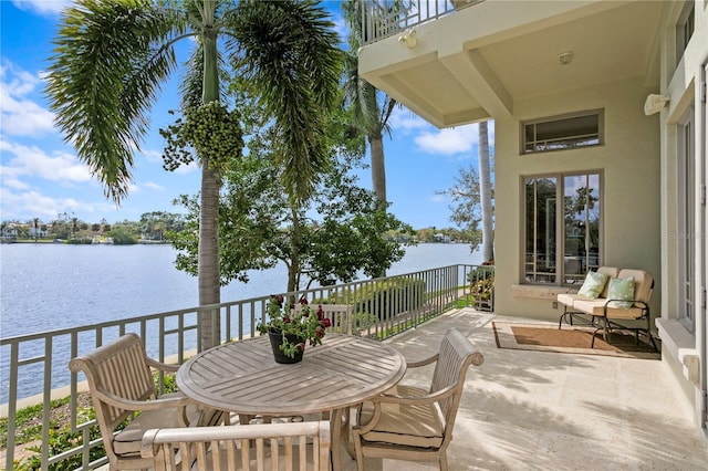 view of patio / terrace featuring a water view and a balcony