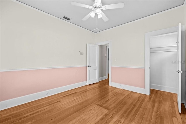 unfurnished bedroom with light wood-style floors, visible vents, a closet, and baseboards