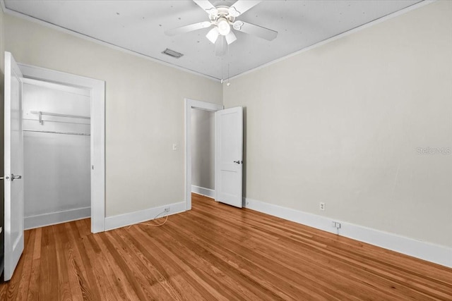 unfurnished bedroom featuring baseboards, visible vents, light wood finished floors, and ornamental molding