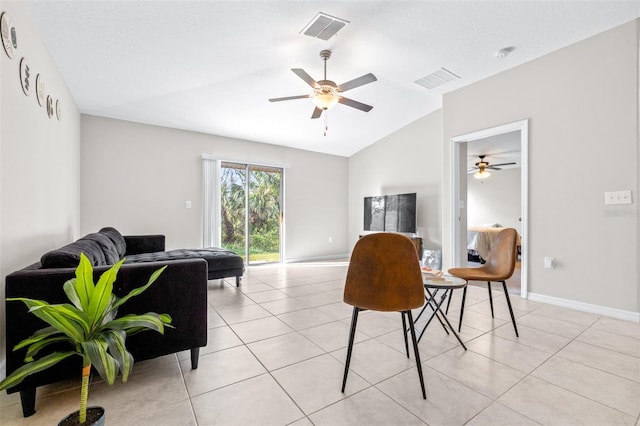 living area with lofted ceiling, light tile patterned floors, baseboards, and visible vents