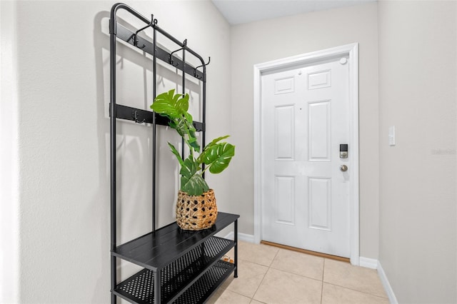 entryway featuring light tile patterned floors and baseboards