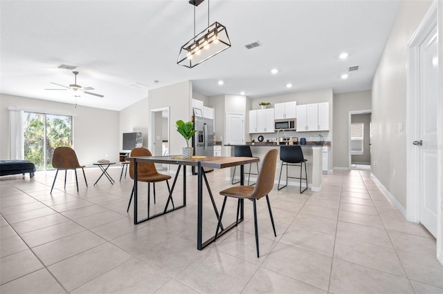 dining area with light tile patterned floors, visible vents, and baseboards