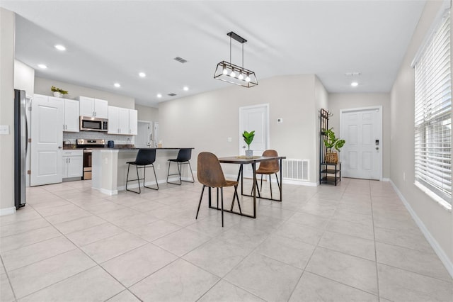 dining space with recessed lighting, visible vents, baseboards, and light tile patterned floors