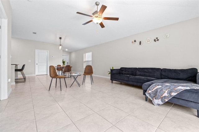 living room with light tile patterned floors, visible vents, baseboards, lofted ceiling, and ceiling fan