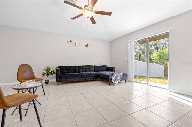 living room featuring light tile patterned flooring, baseboards, and ceiling fan