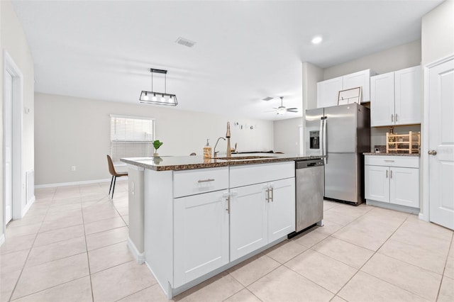 kitchen featuring light tile patterned floors, visible vents, a sink, appliances with stainless steel finishes, and white cabinetry