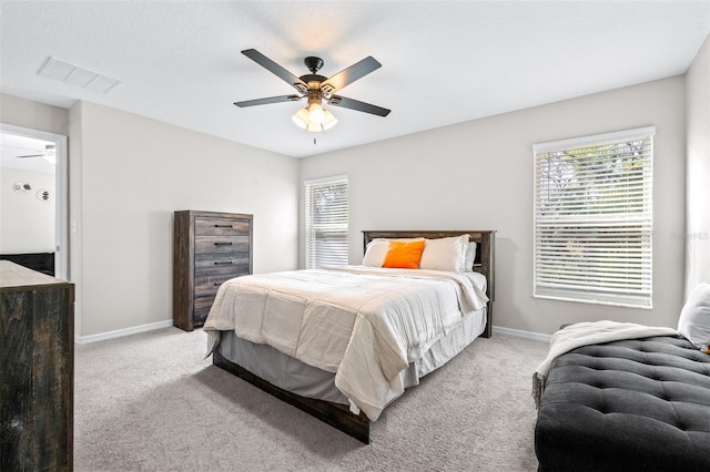 carpeted bedroom with visible vents, baseboards, and ceiling fan