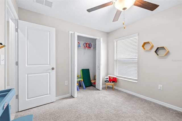 recreation room with visible vents, carpet flooring, baseboards, and ceiling fan