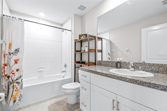 full bath featuring vanity, visible vents, tile patterned flooring, shower / bath combo with shower curtain, and toilet