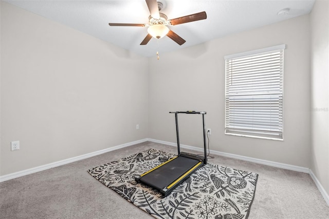 workout area featuring ceiling fan, baseboards, and carpet floors