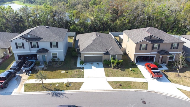 bird's eye view with a wooded view