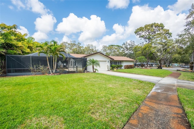 view of front of property featuring glass enclosure, concrete driveway, an attached garage, and a front lawn