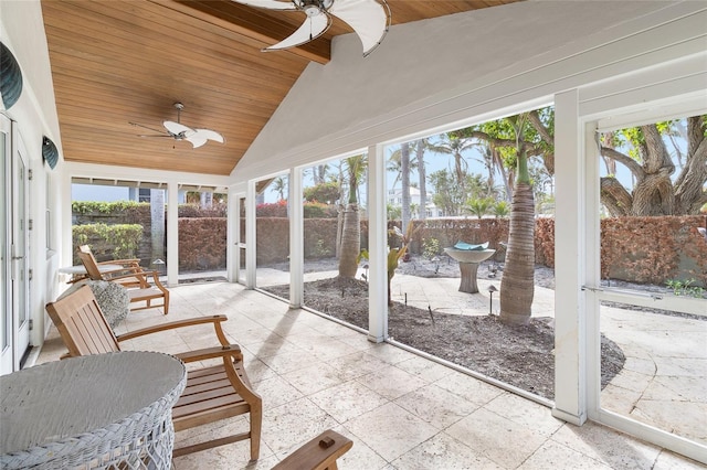 sunroom featuring lofted ceiling, ceiling fan, and wooden ceiling