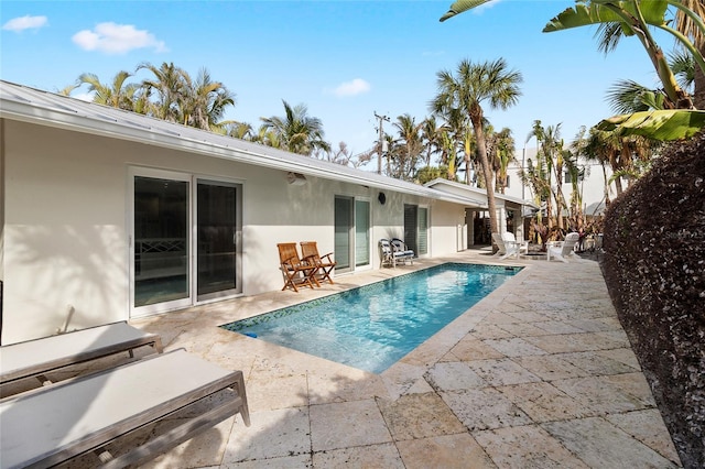 view of swimming pool with a fenced in pool and a patio area