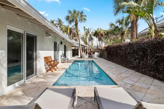 view of swimming pool with a patio, a fenced in pool, and a fenced backyard