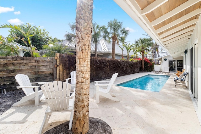 view of swimming pool with a fenced backyard and a patio