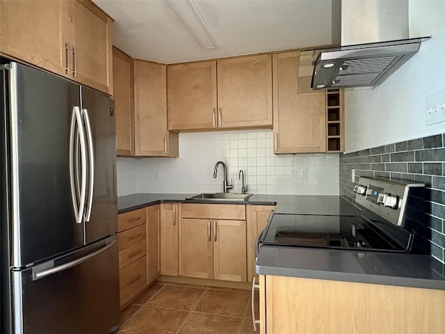 kitchen featuring light brown cabinetry, a sink, dark countertops, tasteful backsplash, and appliances with stainless steel finishes