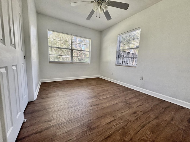 unfurnished bedroom with dark wood-type flooring, baseboards, and ceiling fan