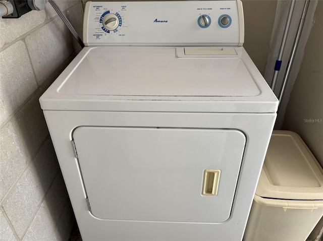 laundry area with washer / dryer and concrete block wall