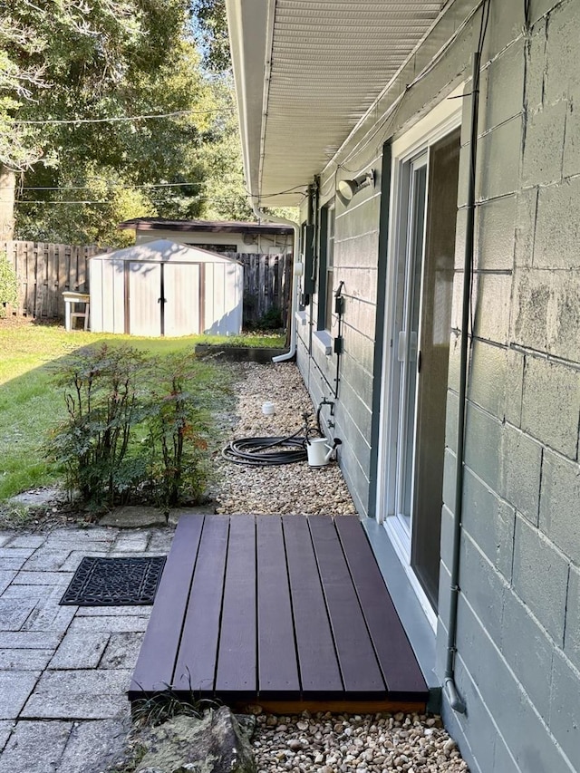 exterior space with an outbuilding, fence, and a shed