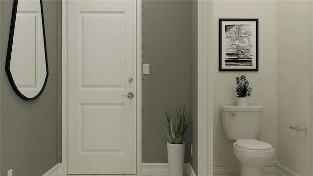 bathroom featuring toilet and baseboards