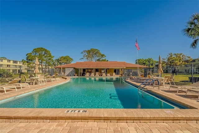 pool featuring a patio and fence