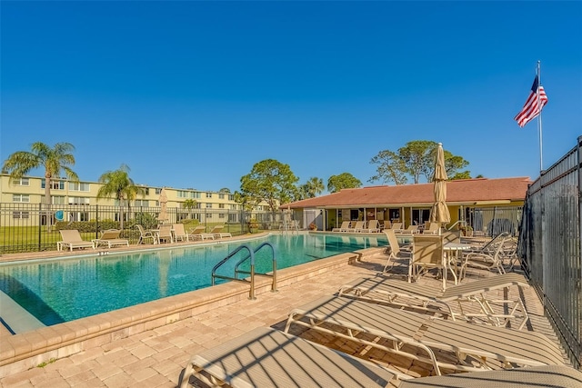 pool featuring a patio area and fence