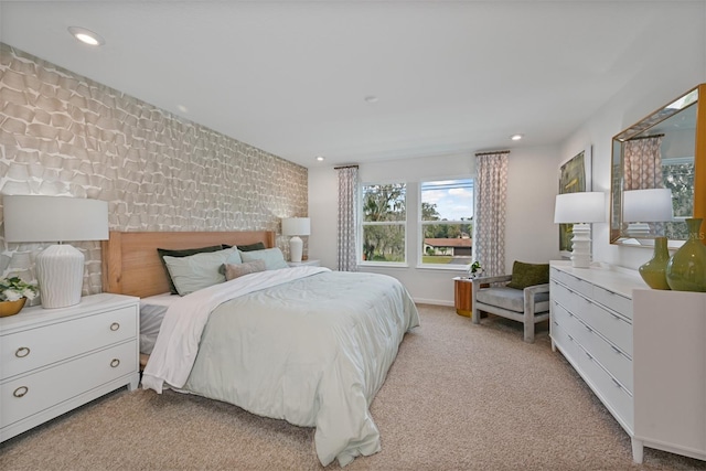 carpeted bedroom featuring an accent wall and recessed lighting