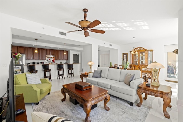 living area featuring visible vents and ceiling fan