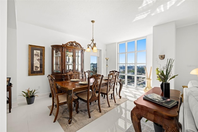 dining area with a wall of windows and baseboards