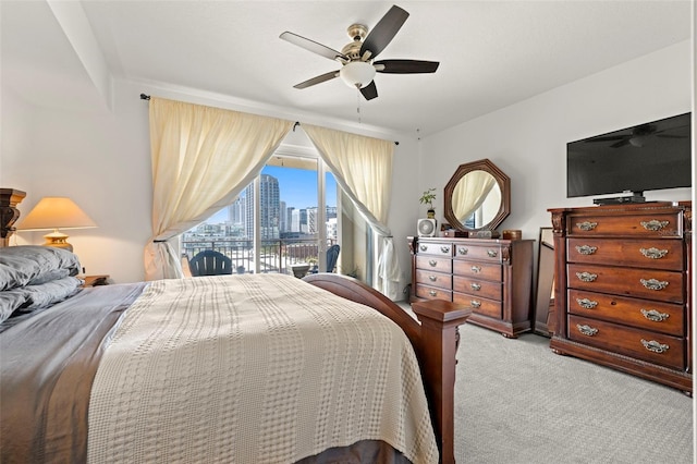 carpeted bedroom with ceiling fan and access to outside