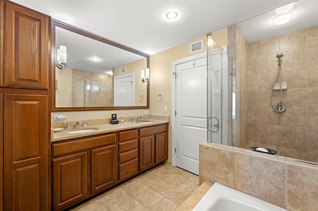 full bathroom featuring a shower stall, visible vents, and a sink