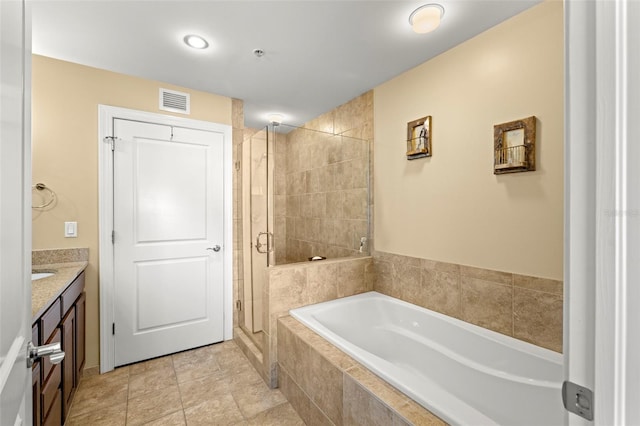 bathroom with vanity, visible vents, a stall shower, a garden tub, and tile patterned floors