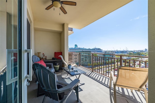 balcony with a view of city and a ceiling fan