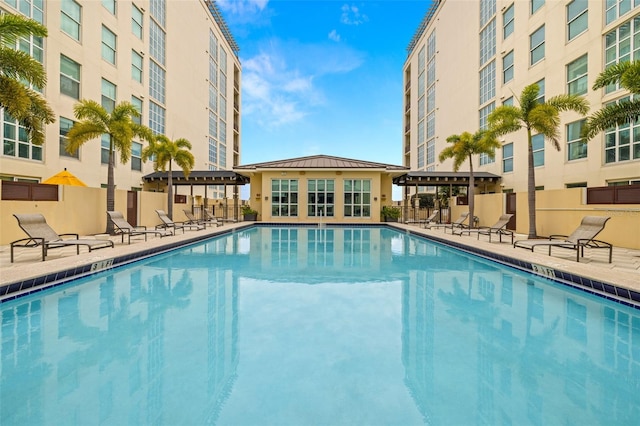 pool featuring a patio, a pergola, and fence