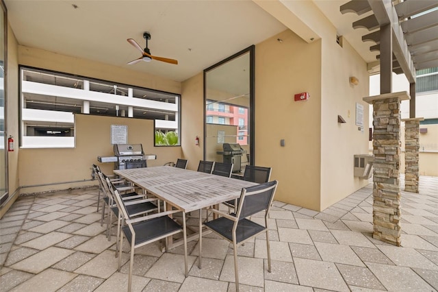 view of patio with grilling area, outdoor dining space, and ceiling fan