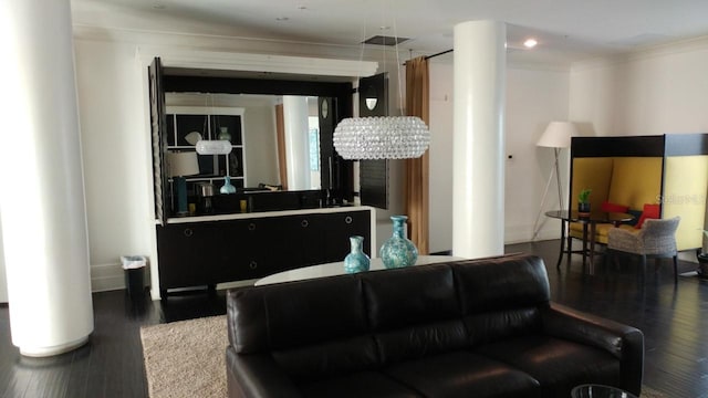 living room with crown molding, wood finished floors, and visible vents