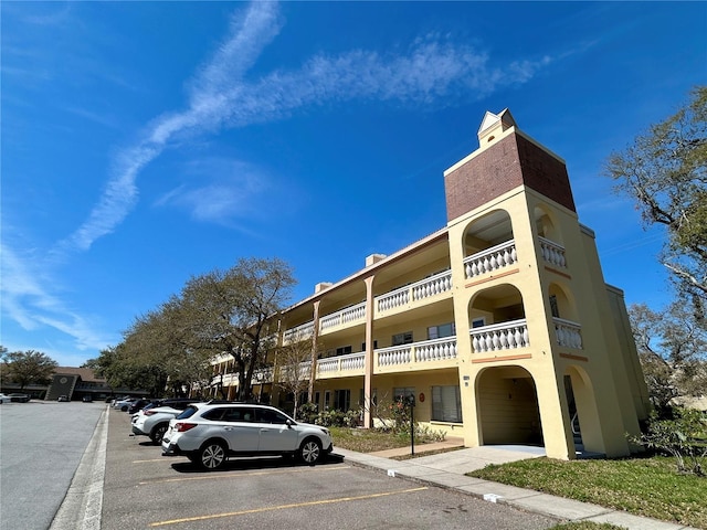 view of building exterior featuring uncovered parking