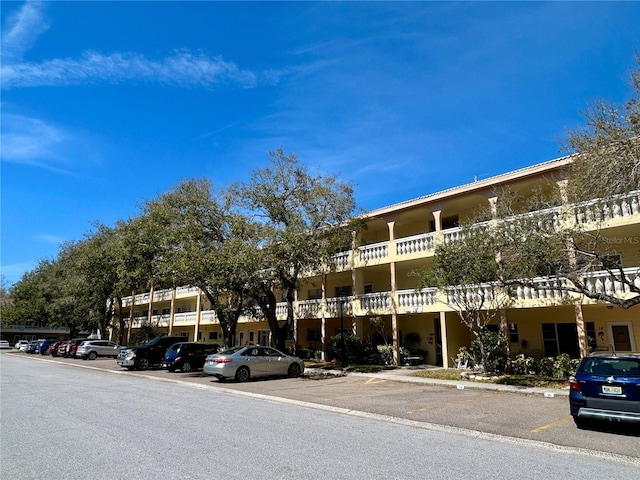 view of building exterior with uncovered parking