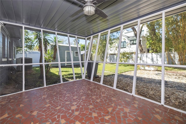 unfurnished sunroom with a ceiling fan