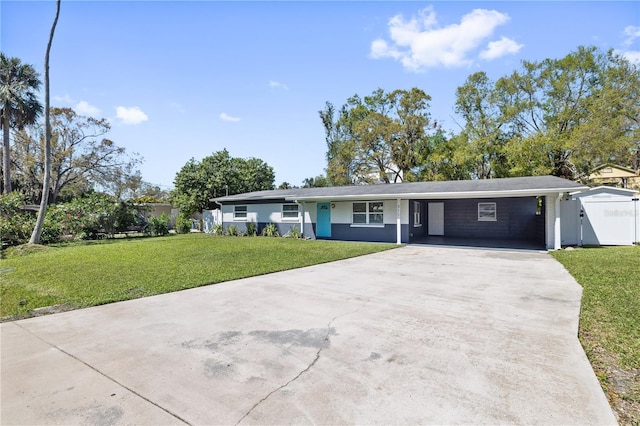 ranch-style house with a front lawn, a carport, and driveway