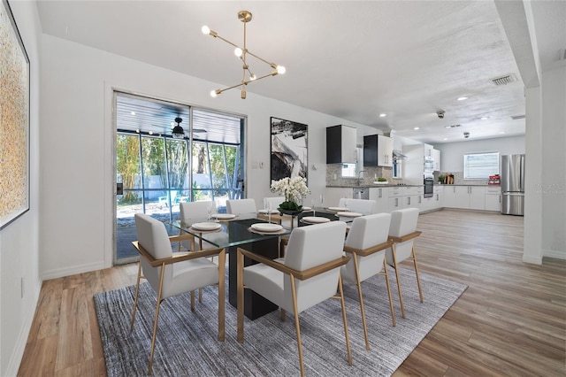 dining area with recessed lighting, a notable chandelier, light wood-style flooring, and visible vents