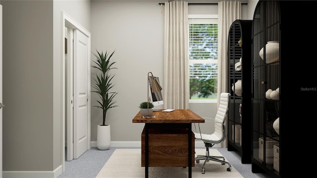 office area featuring carpet, a healthy amount of sunlight, and baseboards