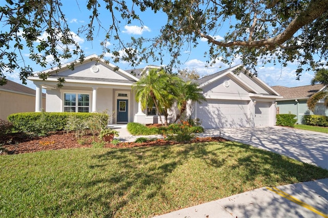 view of front of home featuring stucco siding, a front yard, an attached garage, and driveway